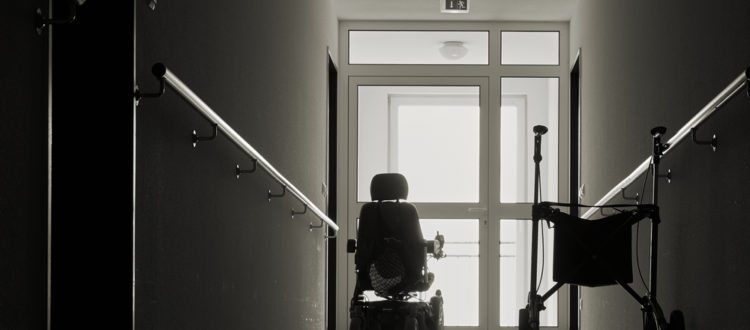 nursing home neglect lawyer NJ - Wheel chair in empty dark hallway